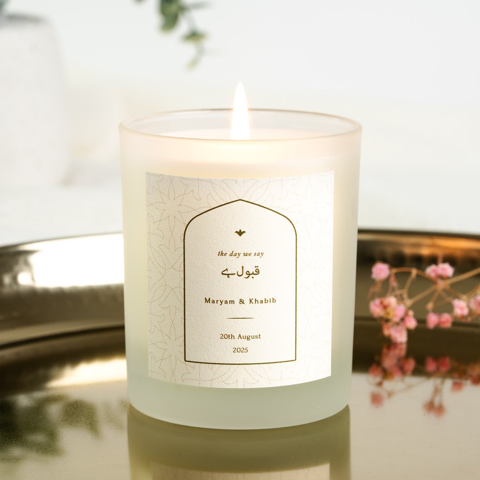 Personalised nikah candle with a fine gold arch framing the Arabic phrase for consent