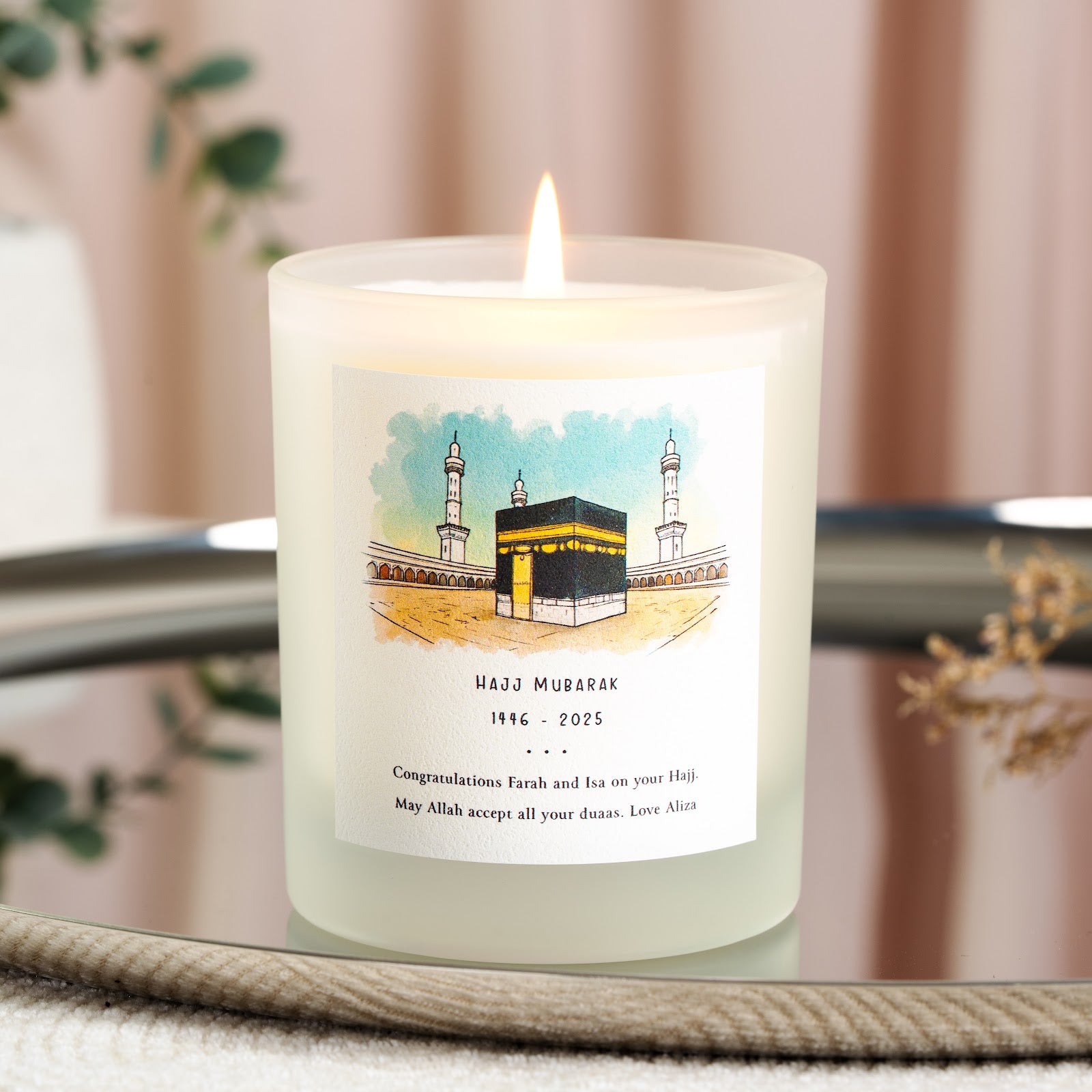 Watercolour Kaaba and minarets in deep teal on a personalised Hajj candle label