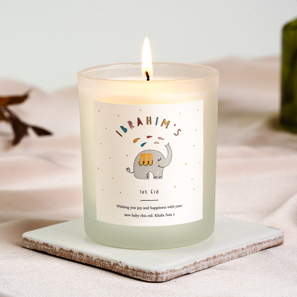 Personalised first Eid candle with a grey elephant beneath colourful dotted lettering