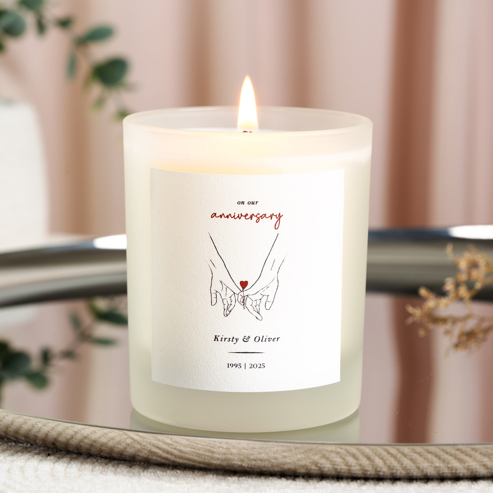 Holding hands illustration above the year range on a personalised anniversary candle