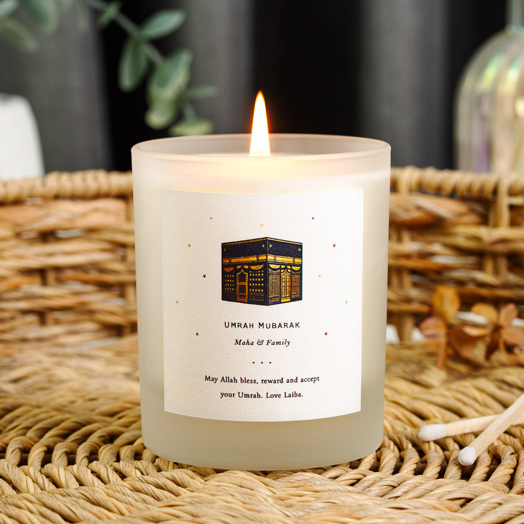 Personalised Umrah candle with a Kaaba illustration above the family's name