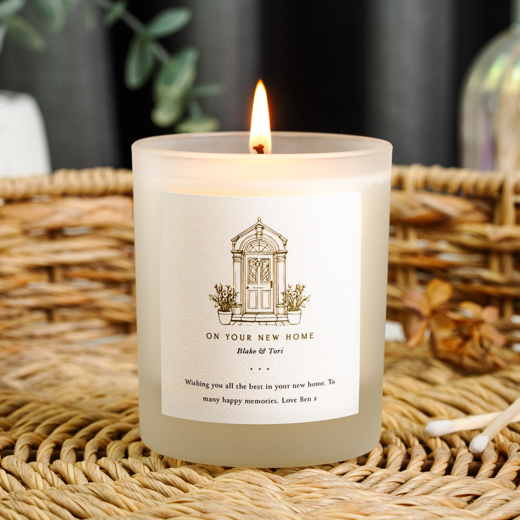 Gold line illustration of a panelled front door on a personalised new home candle label
