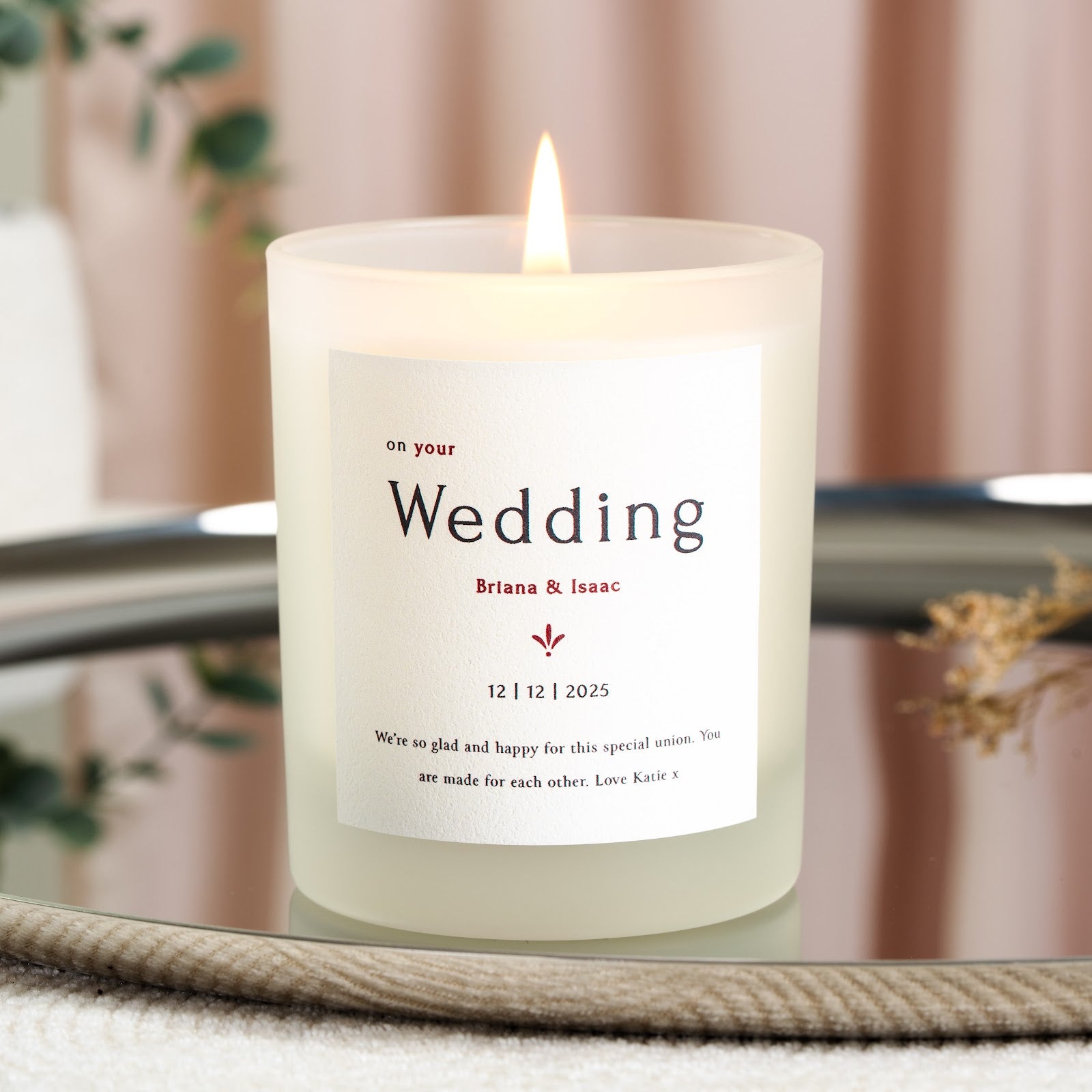Personalised wedding candle with Wedding in large black serif and the names in bold red type