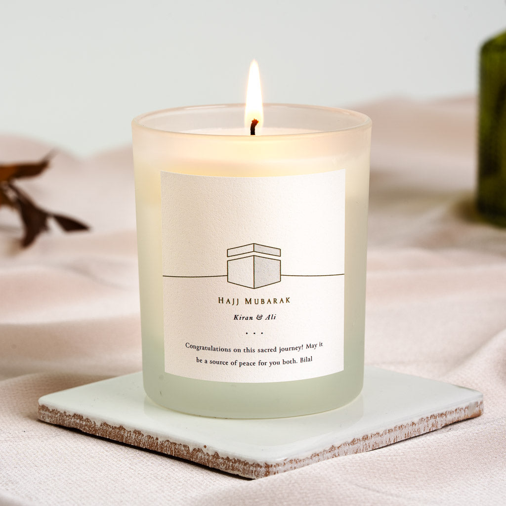 Personalised Hajj candle with a line-drawn Kaaba above the greeting in capitals