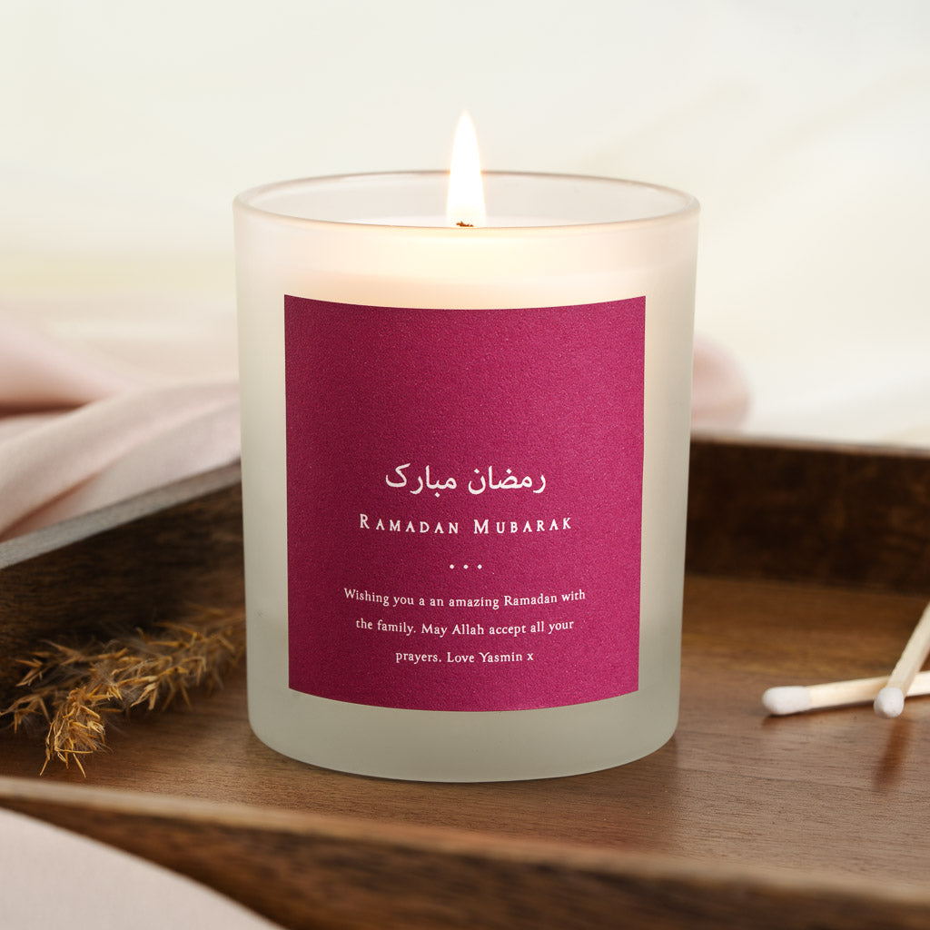 Arabic Ramadan Mubarak greeting and its translation on a solid magenta personalised candle