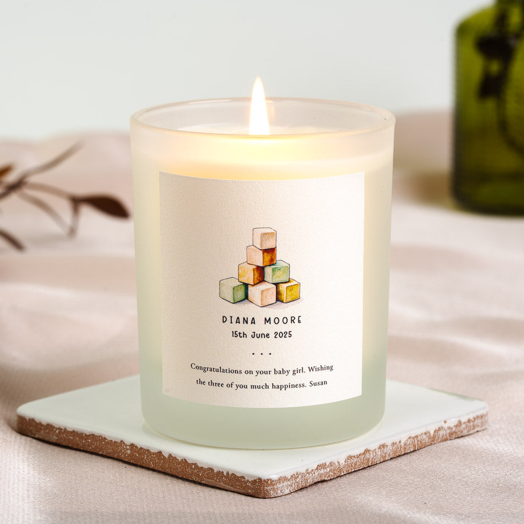 Personalised new baby candle with a painted stack of wooden building blocks