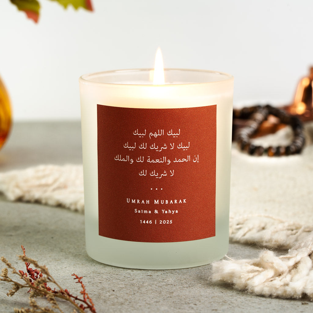 Talbiyah in white Arabic on a terracotta personalised Umrah candle above the couple's names