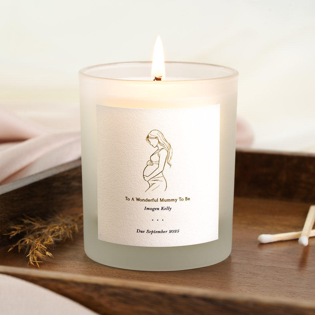 Personalised candle with a pregnant silhouette in fine gold linework and the due date