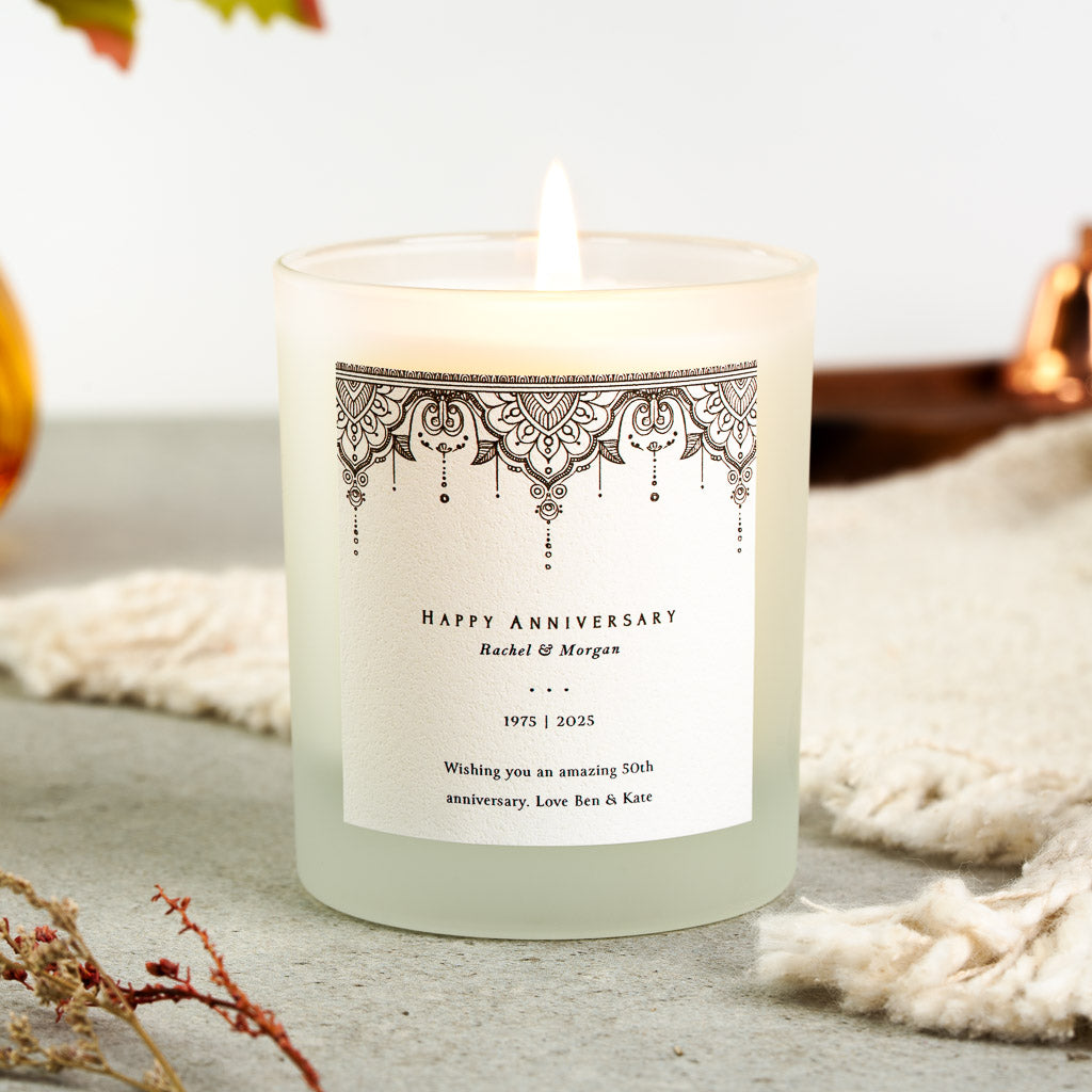 Personalised anniversary candle with an ornate border along the top edge of the label