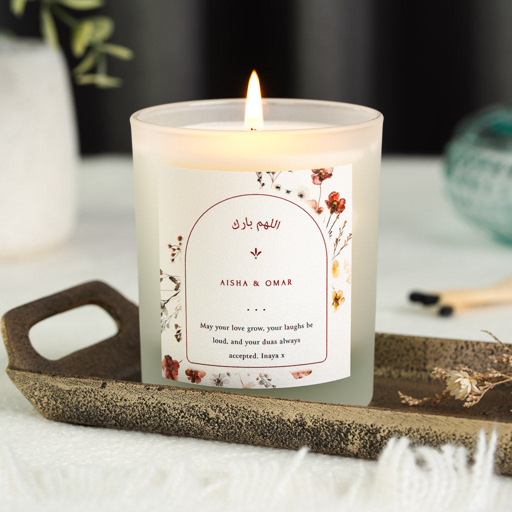 Personalised nikah candle with red and amber pressed wildflowers around a red-outlined arch