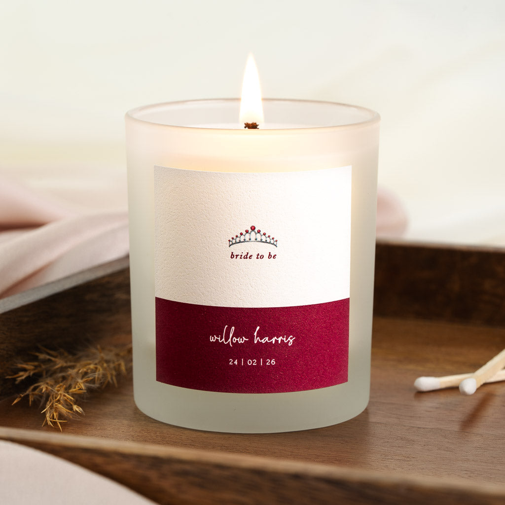 Tiara illustration above a deep burgundy band on a personalised engagement candle label