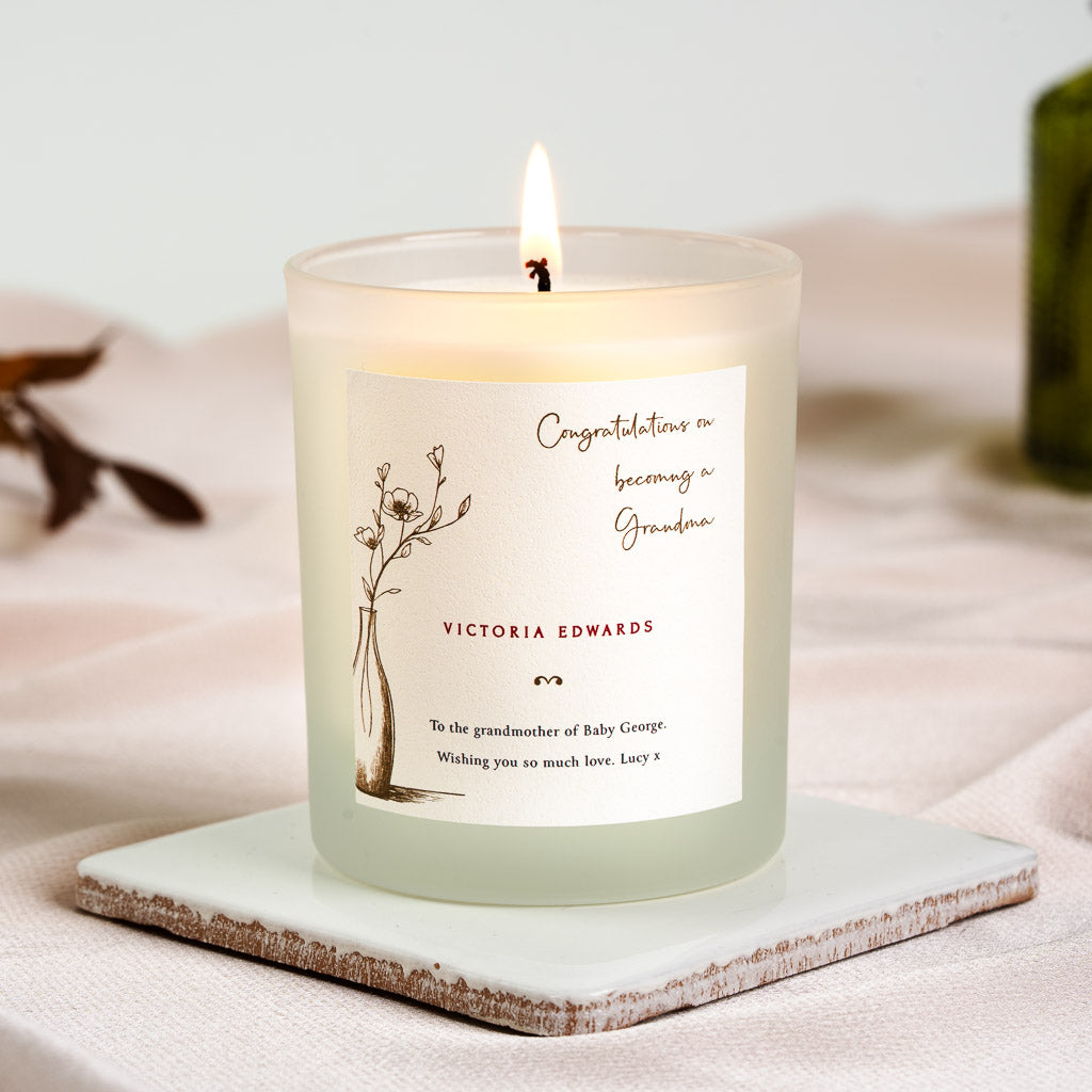 Hand-drawn vase of flowers beside brown script on a personalised new grandma candle label