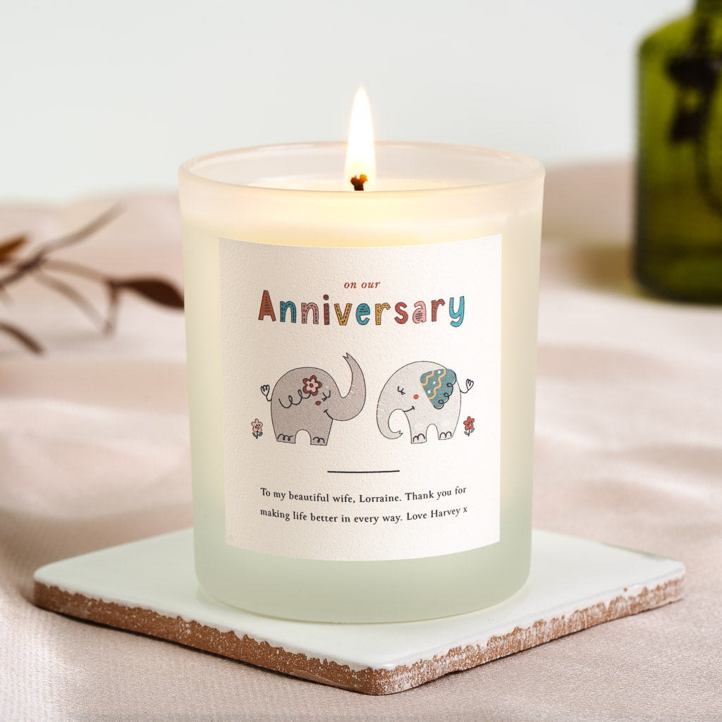 Whimsical elephant illustration above the message on a personalised anniversary candle