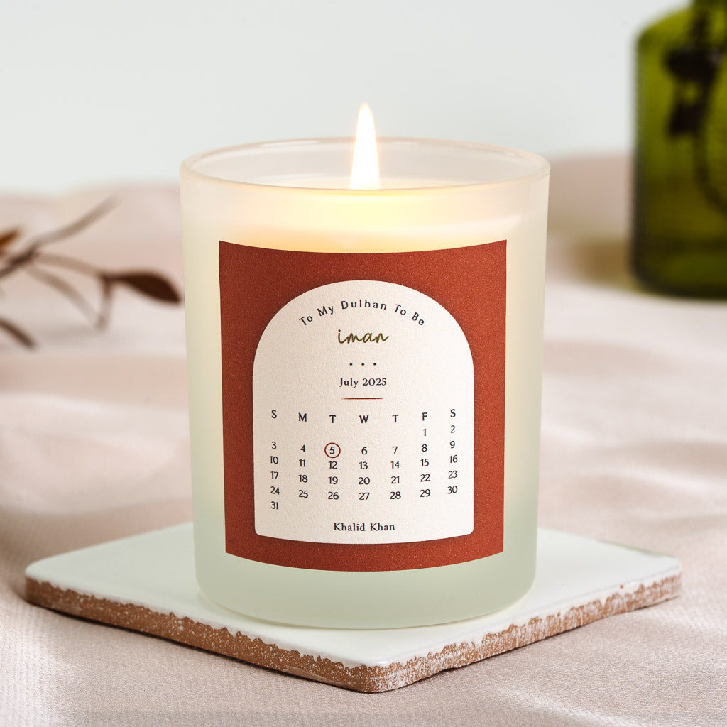 White arch on burnt orange with a curved heading on a personalised wedding countdown candle