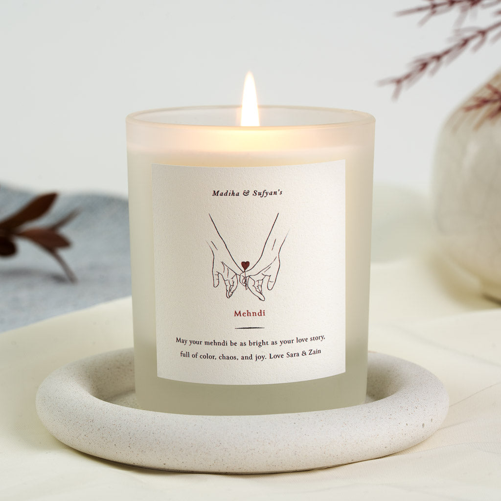 Personalised mehndi candle with two hands reaching together and a small heart between them
