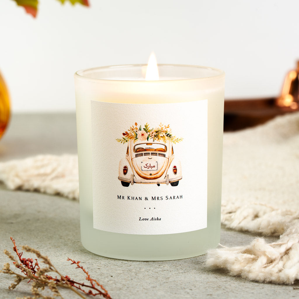 Vintage car topped with peach and green flowers on a personalised nikah mubarak candle