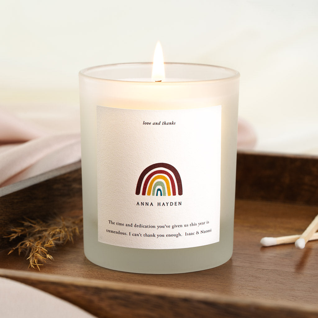 Personalised thank you candle with a rainbow beneath small italic lettering