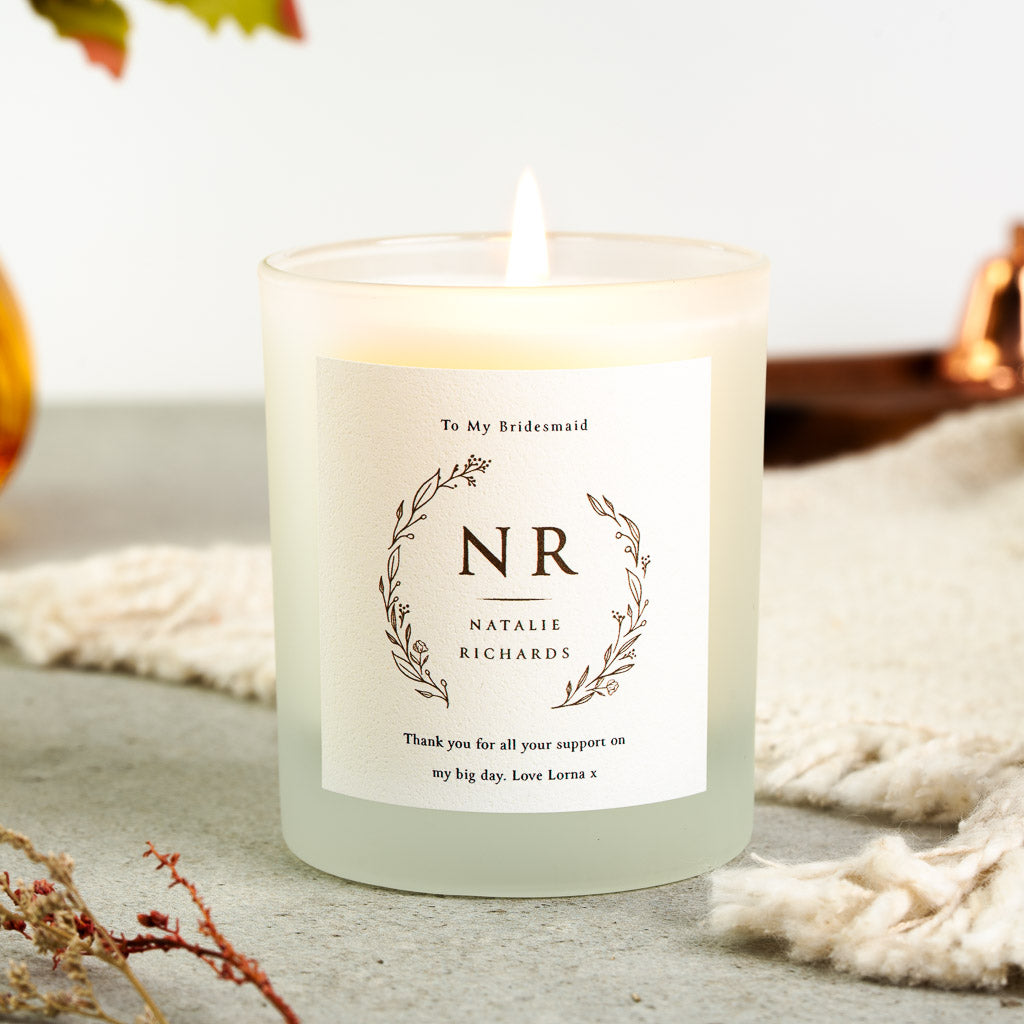 Personalised bridesmaid candle with a hand-drawn botanical wreath framing the initials