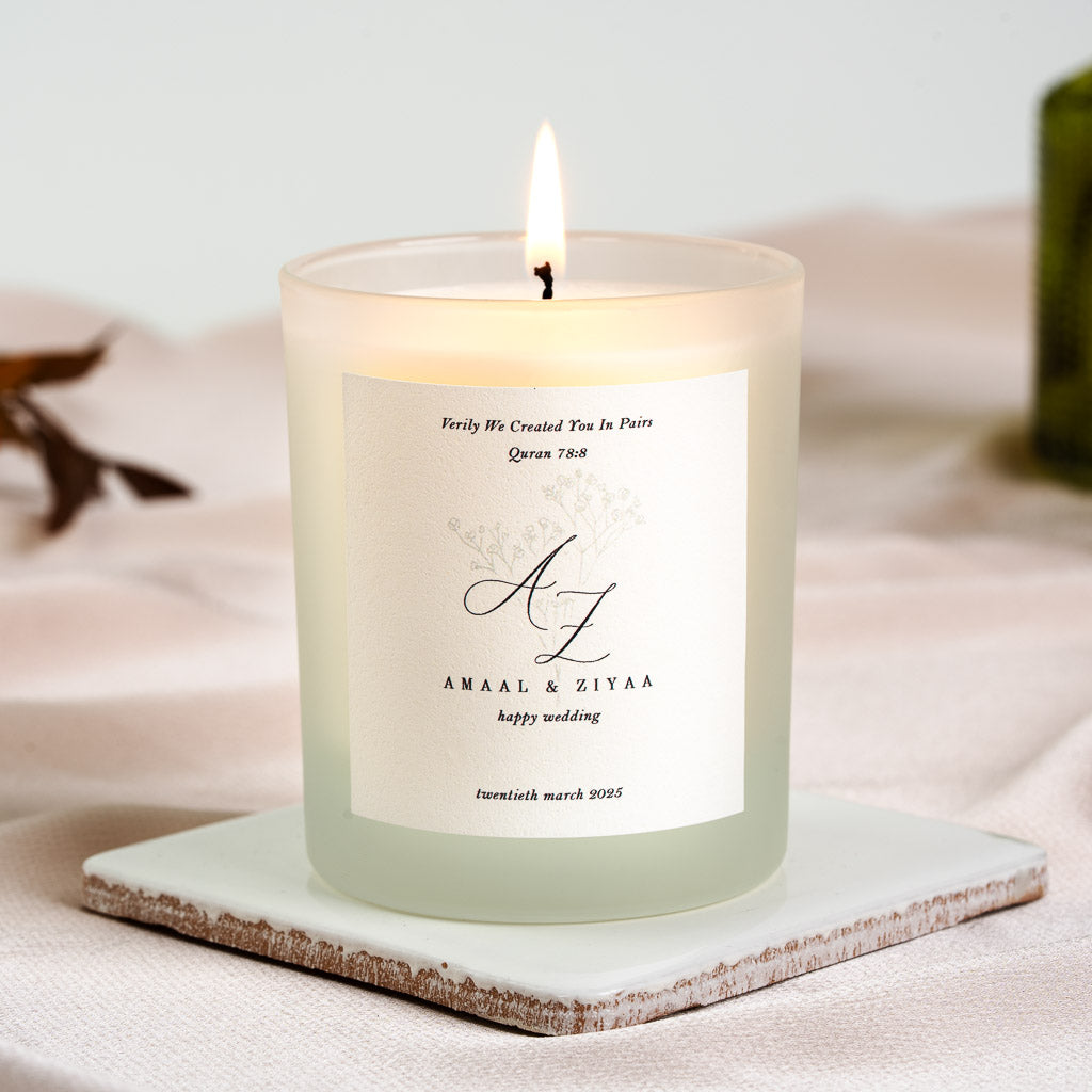 Surah An-Naba above monogram initials and pressed wildflowers on a personalised nikah candle