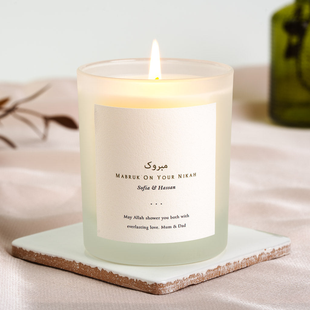 Personalised nikah candle with brown script above a mabruk greeting in capitals