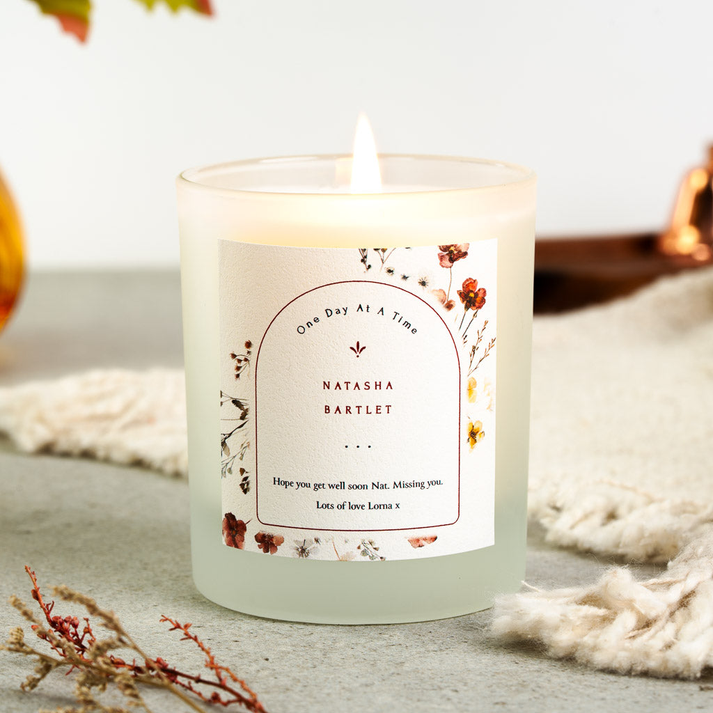 Wildflowers scattered along the edges of an arched border on a personalised get well candle