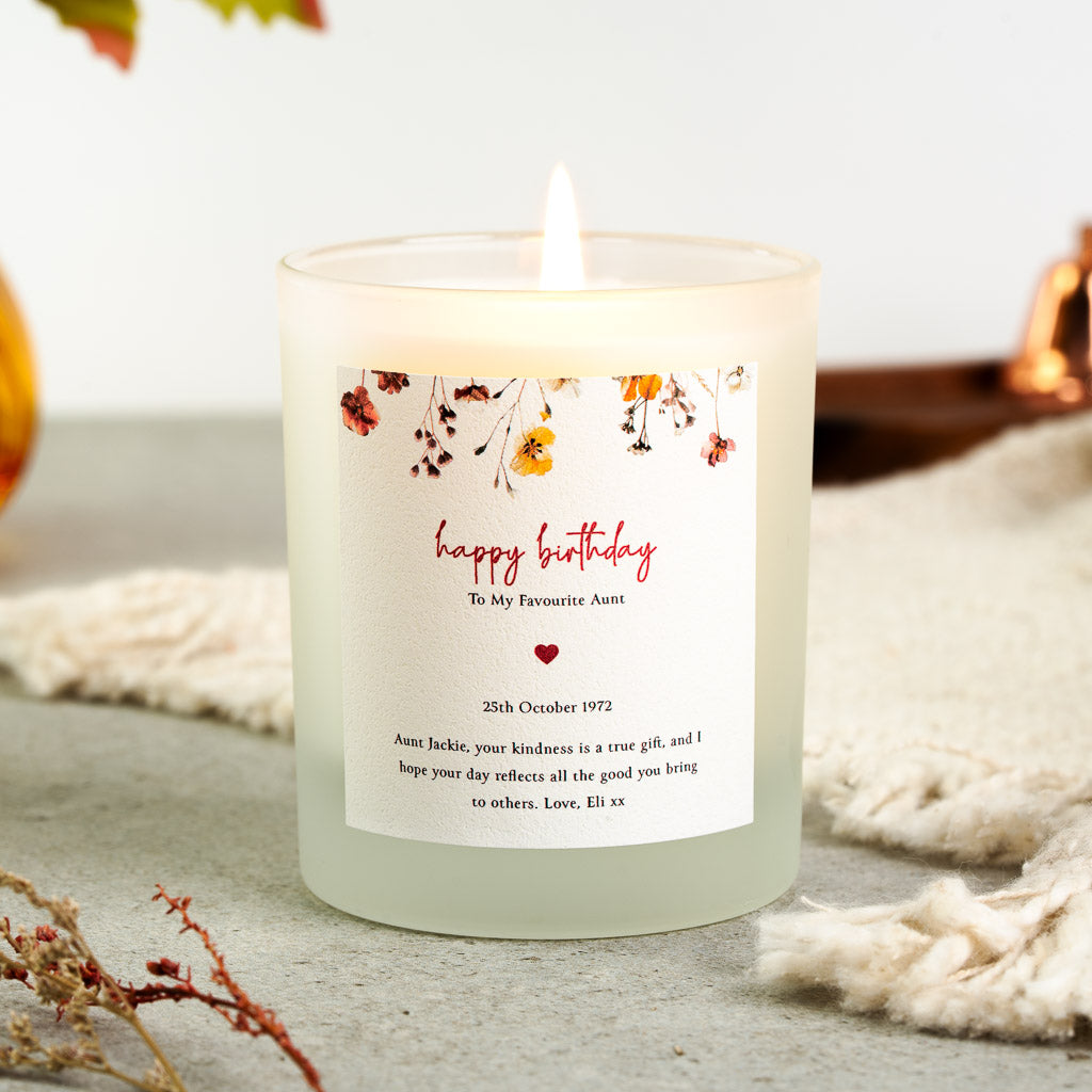 Personalised birthday candle with a heart beneath red script inside a floral border