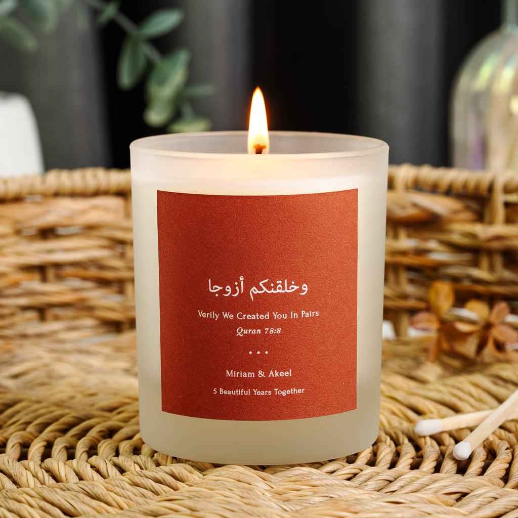 Personalised anniversary candle with Surah An-Naba in white script on deep terracotta