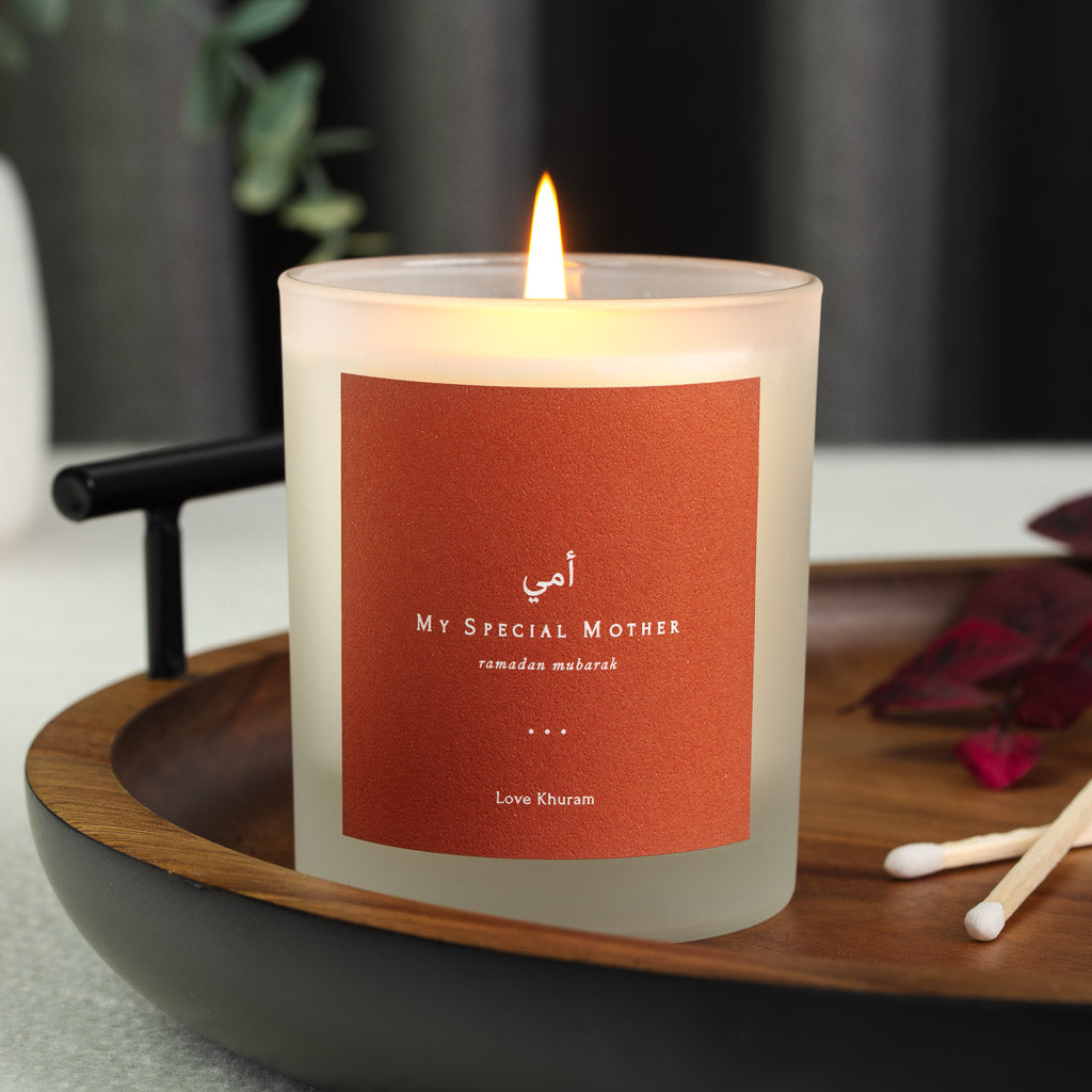 White Arabic script on a solid burnt orange personalised Ramadan candle label