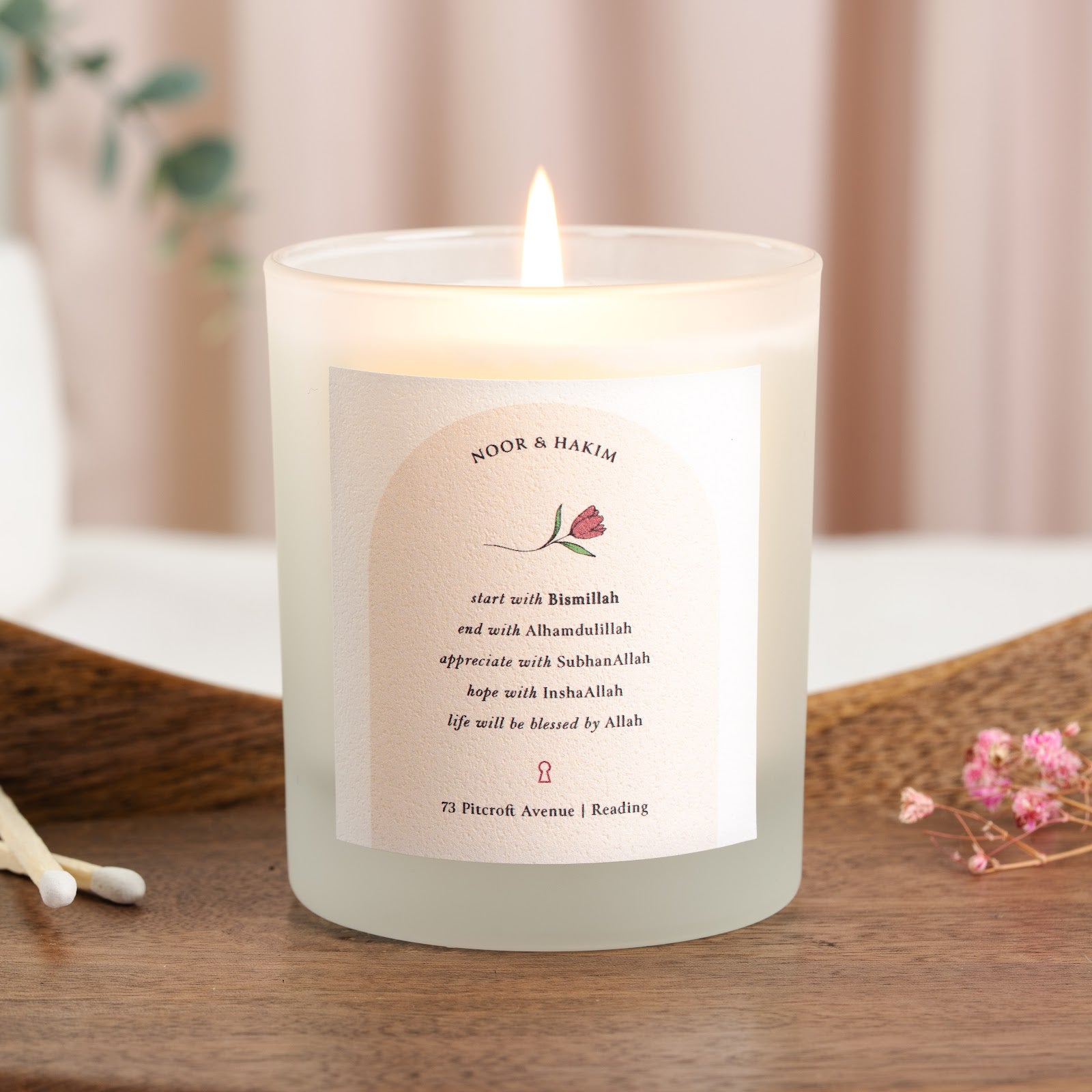 Personalised Islamic new home candle with a single flower sketch inside a pale arch