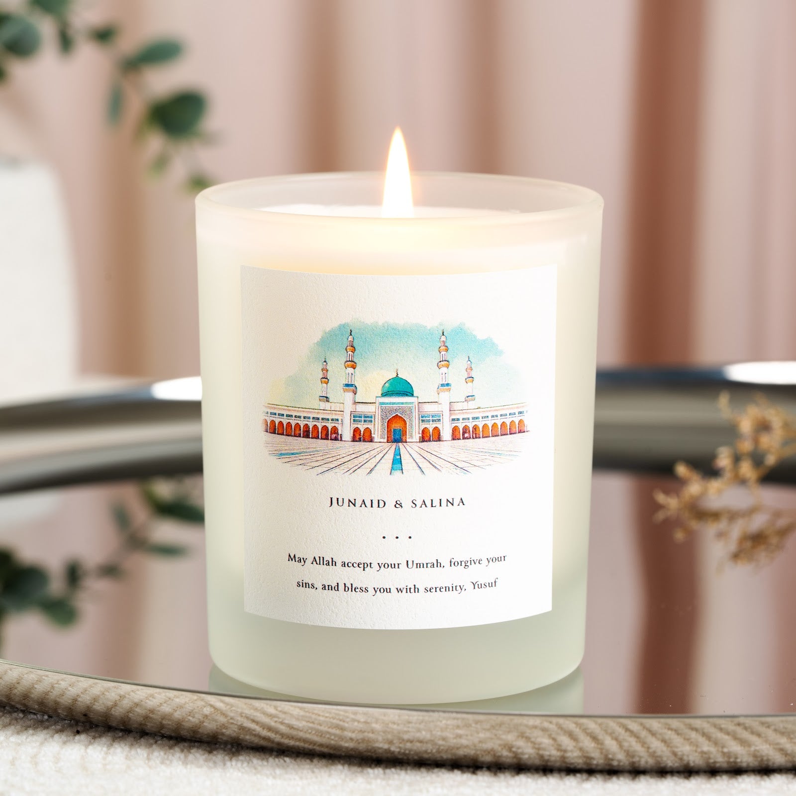 Personalised Umrah candle with a watercolour mosque and courtyard above the names