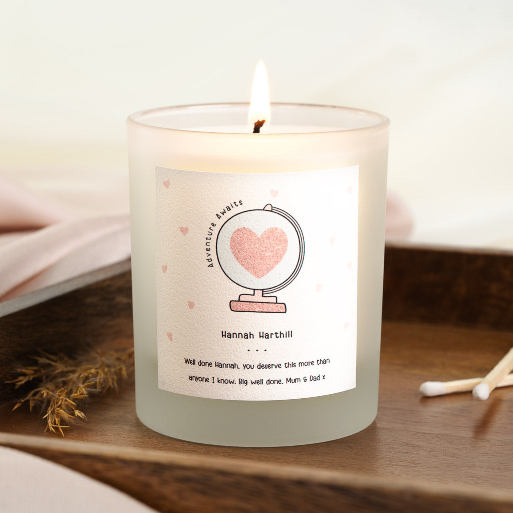 Personalised graduation candle with a hand-drawn globe holding a heart at its centre
