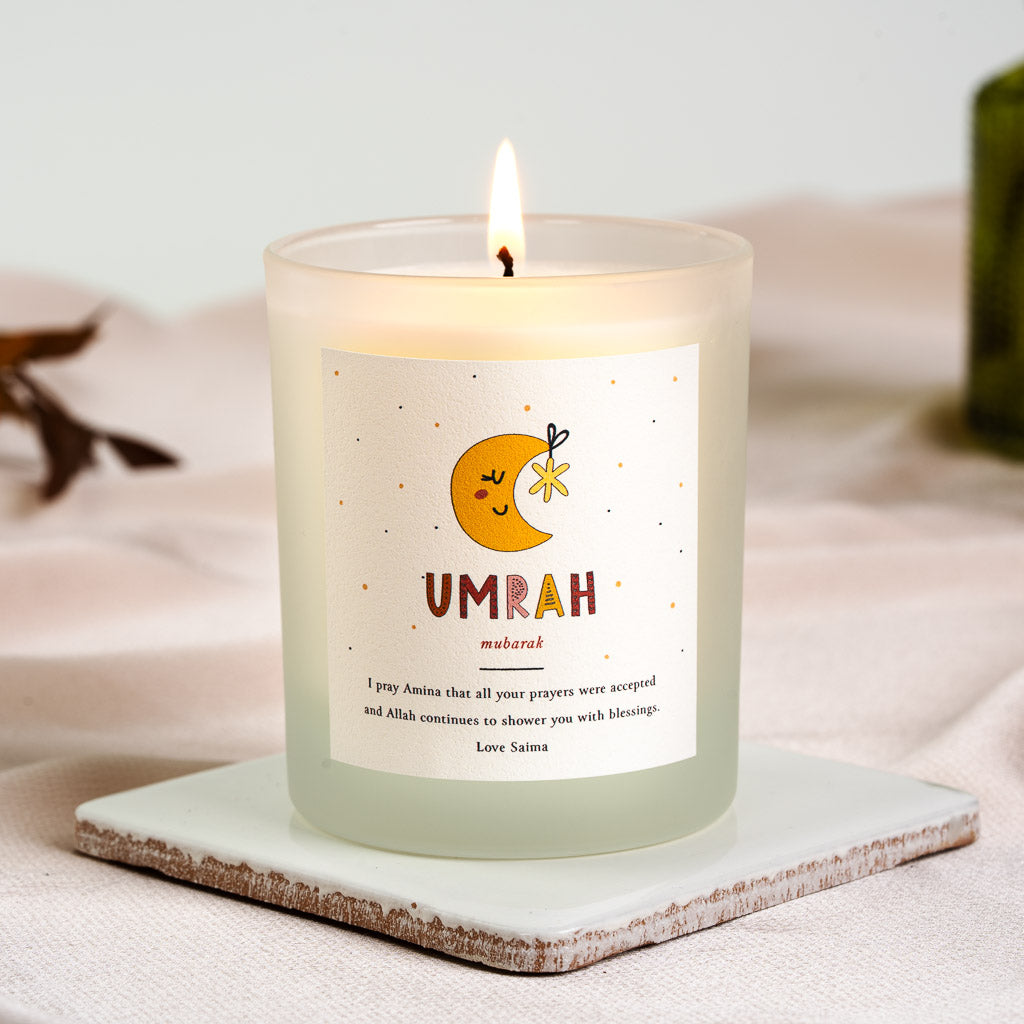 Personalised Umrah mubarak candle with an illustrated moon and star above coloured type