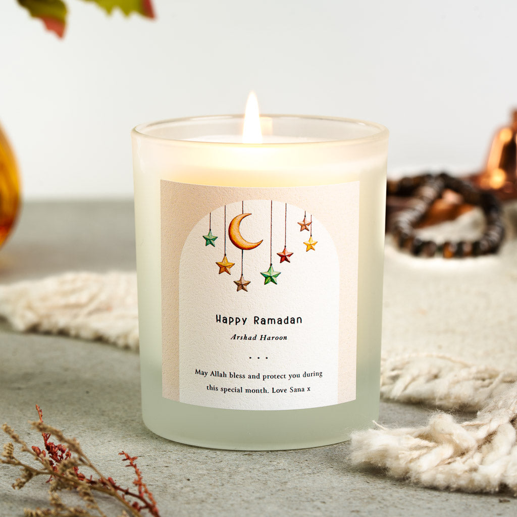 Personalised Ramadan candle with hanging stars and a crescent moon in a watercolour arch