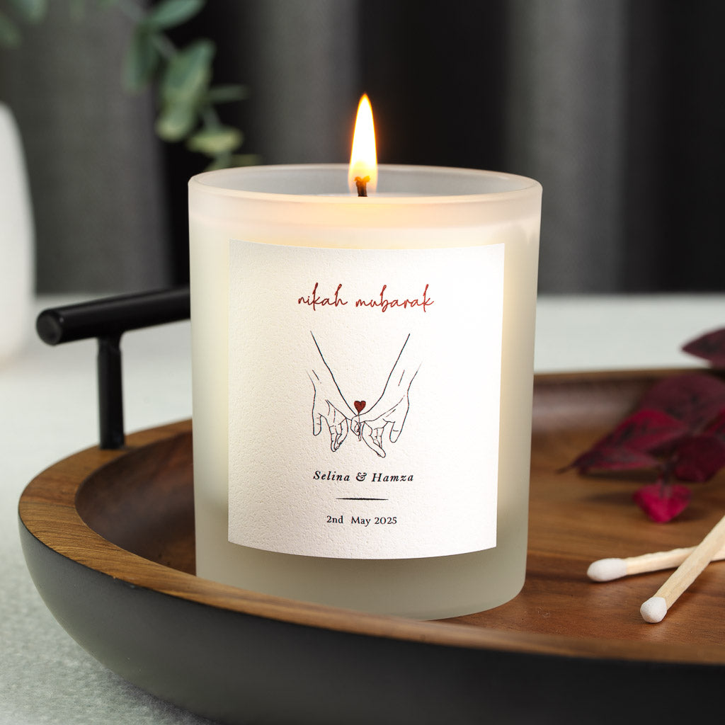Nikah mubarak in red script above a line illustration on a personalised candle label