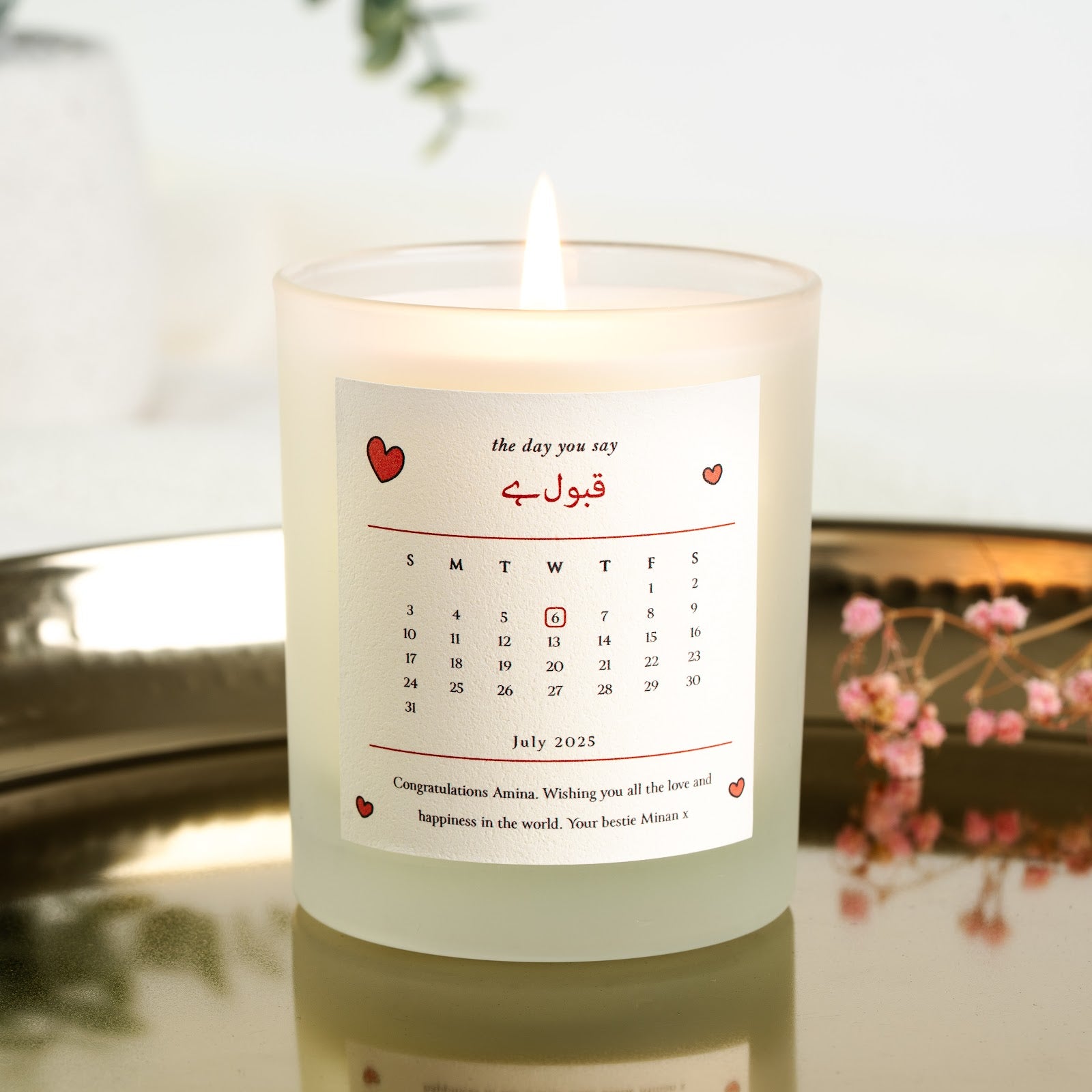 Personalised nikah candle with a monthly calendar grid and the date circled in red
