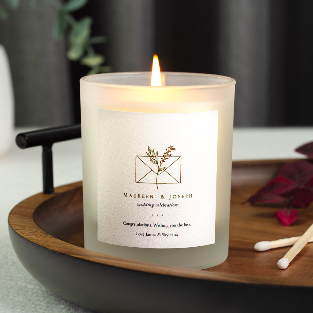 Envelope illustration with a leaf and berry sprig on a personalised wedding candle label