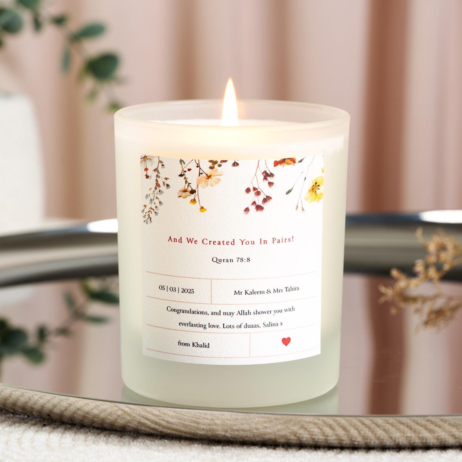 Pressed cream and rust florals above Surah An-Naba on a personalised nikah candle