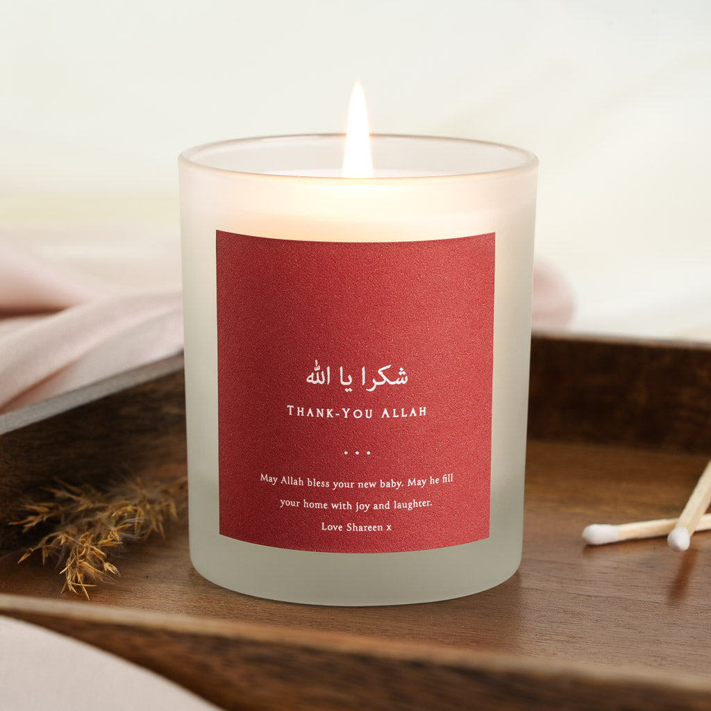 Personalised new baby candle with white Arabic script on a red background