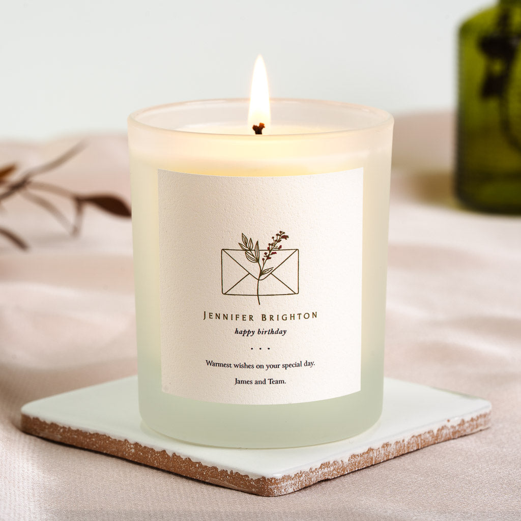 Line-drawn envelope above the recipient's name on a personalised birthday candle label