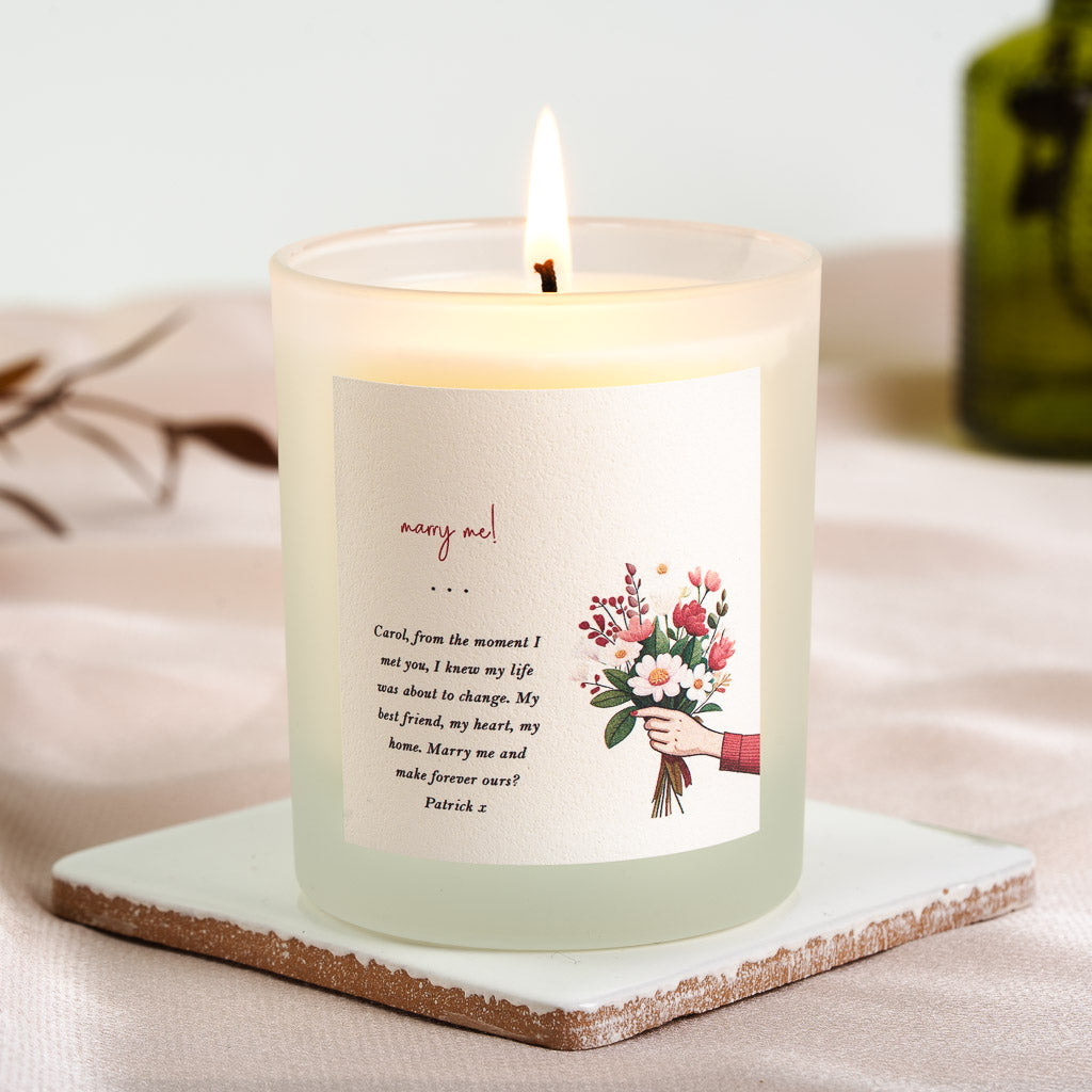 Personalised proposal candle with a red-sleeved hand holding a pink and red bouquet
