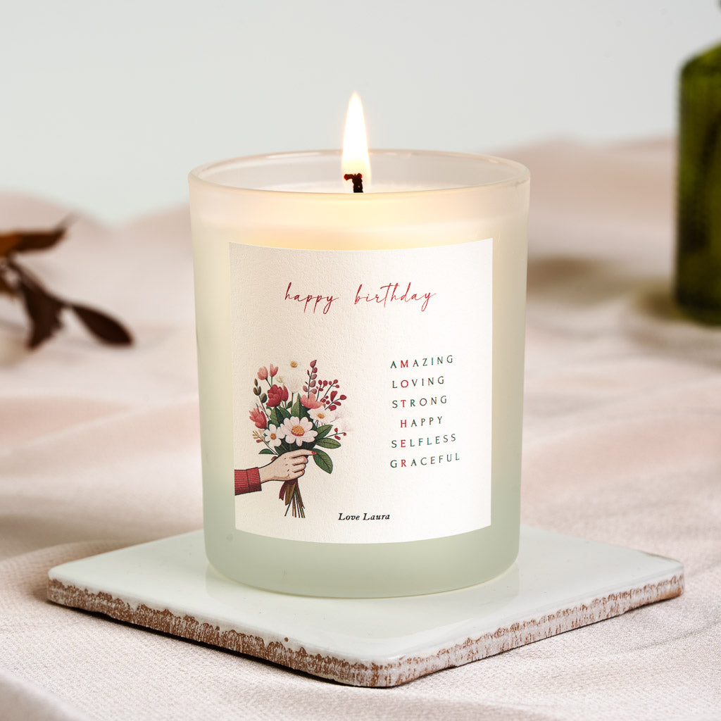 Personalised birthday candle with stacked adjectives in red and black beside a bouquet