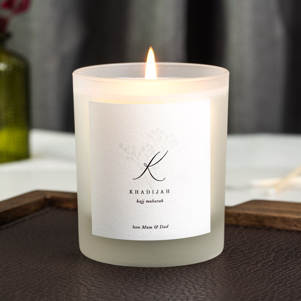 Personalised Hajj candle with a monogram initial above the greeting in lower case script