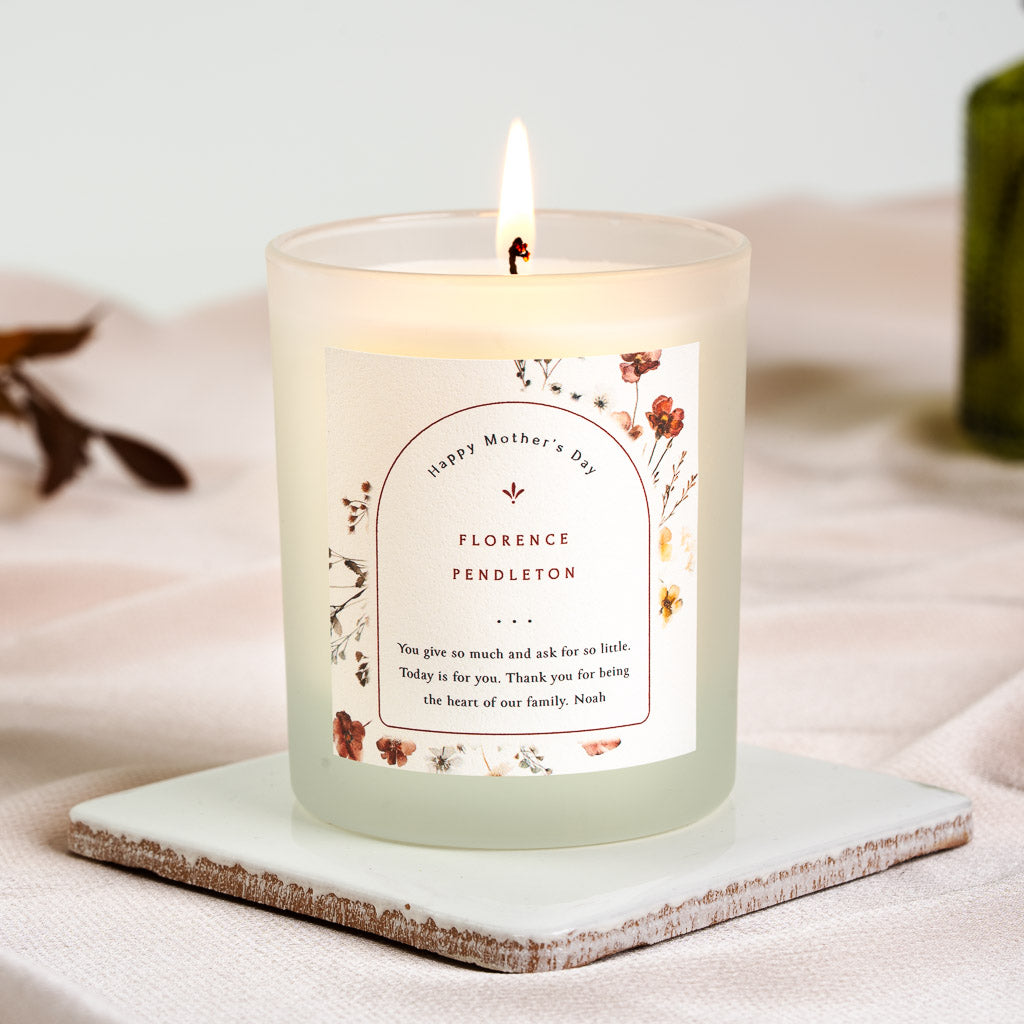 Single pink rose set where two thin rules break on a personalised Mother's Day candle