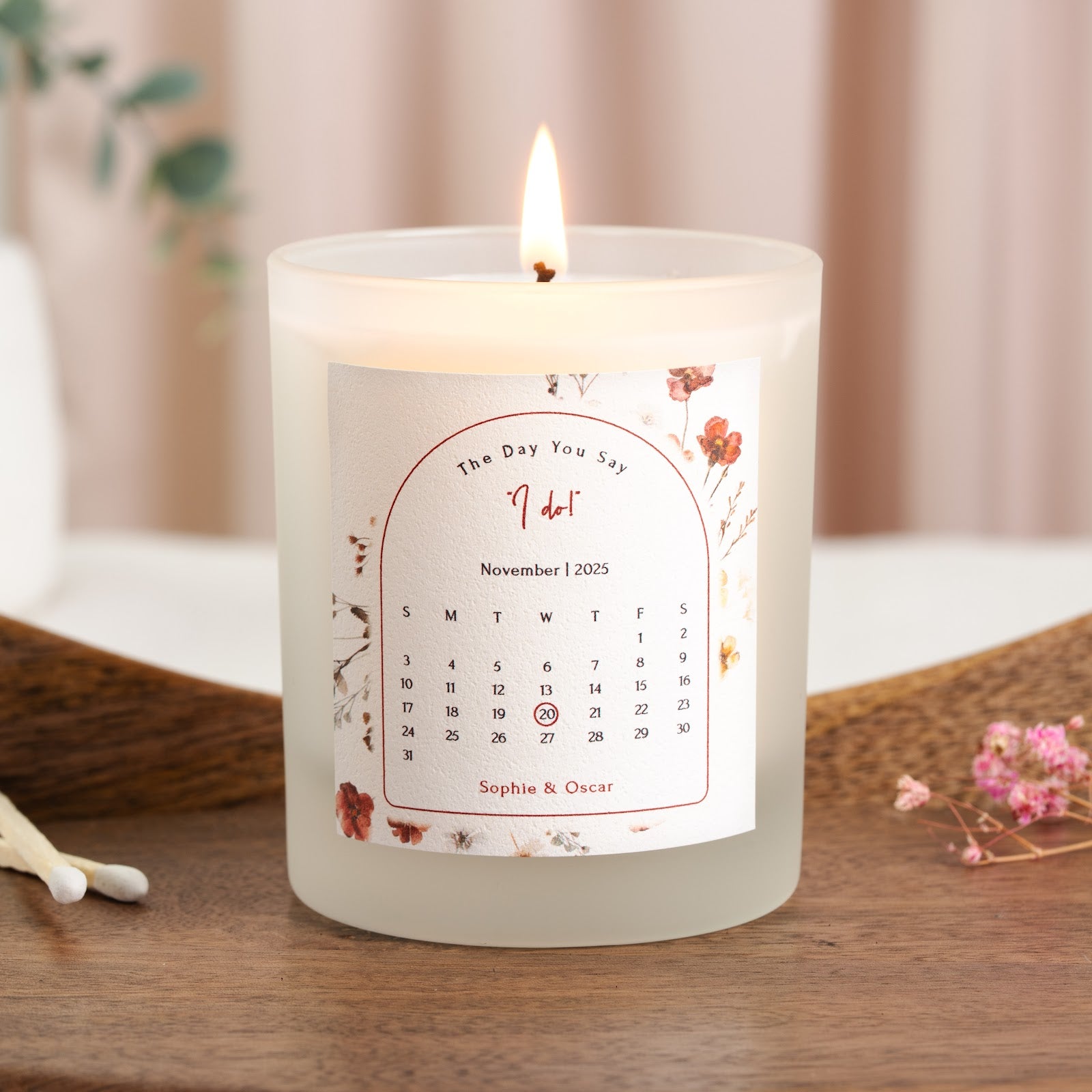 Arched panel holding a calendar grid with the day circled on a personalised engagement candle