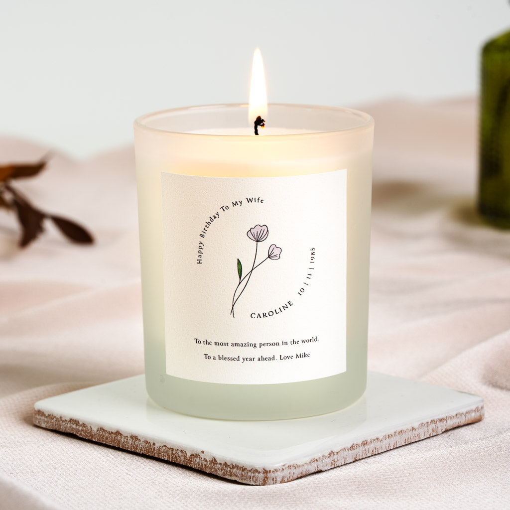 Personalised birthday candle with a curved heading above a single flower illustration
