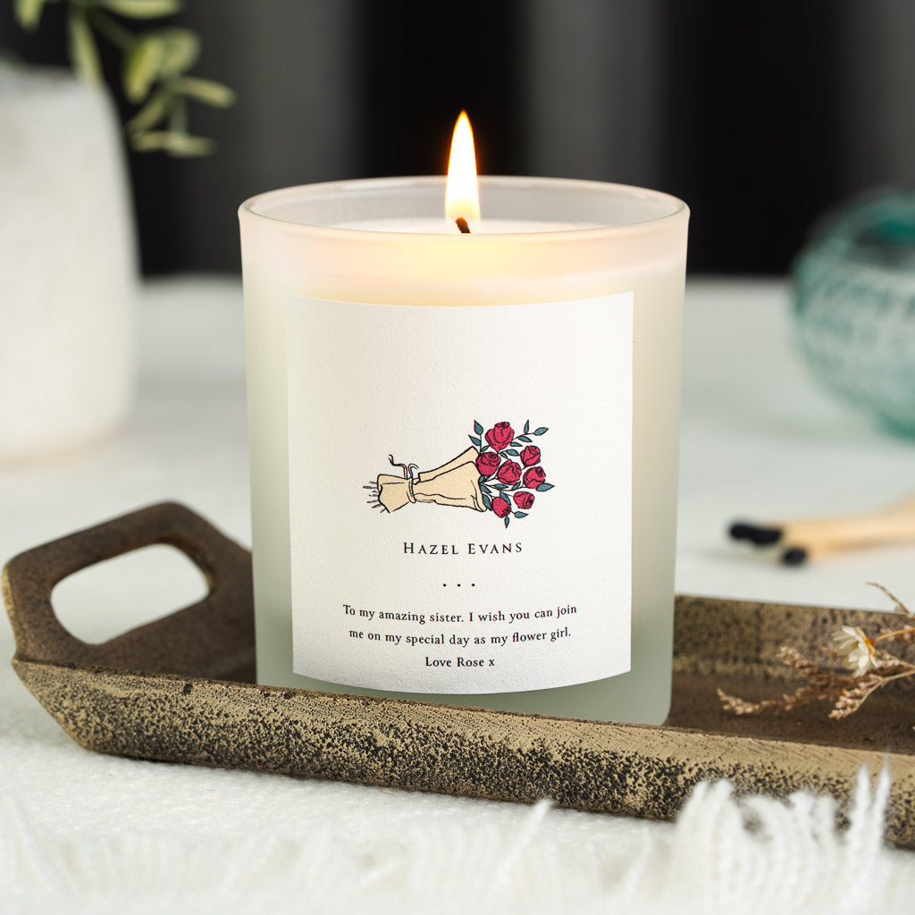Illustrated hand holding red roses on a personalised flower girl wedding candle
