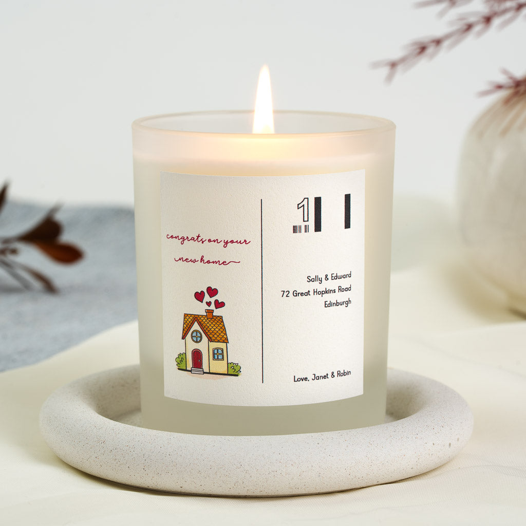 Illustrated cottage with hearts rising from its chimney on a personalised new home candle