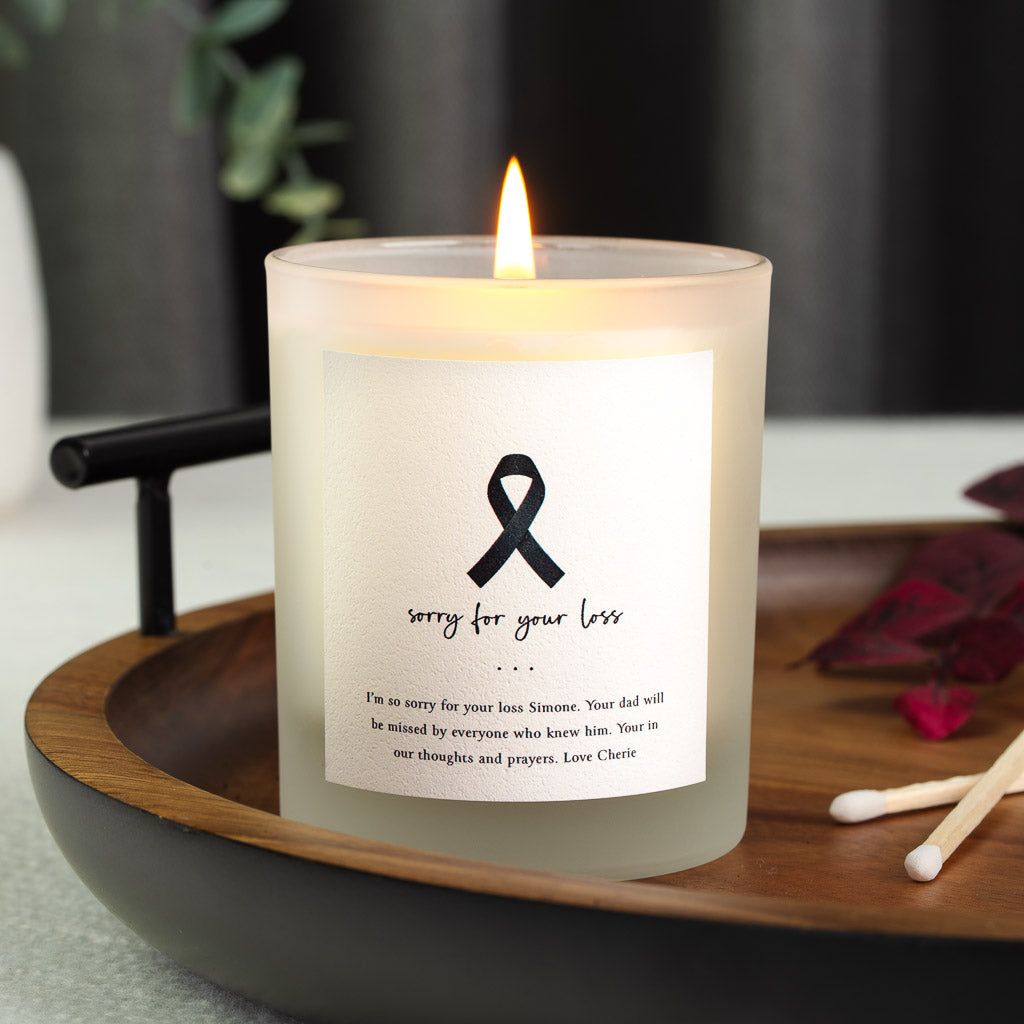 Personalised sympathy candle with a solid black ribbon at the centre of the label