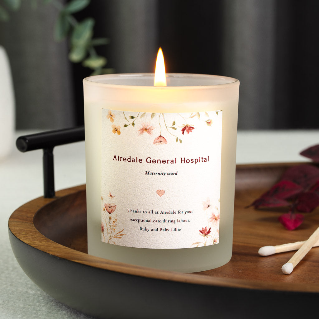 Trailing florals above a small heart motif on a personalised staff thank you candle