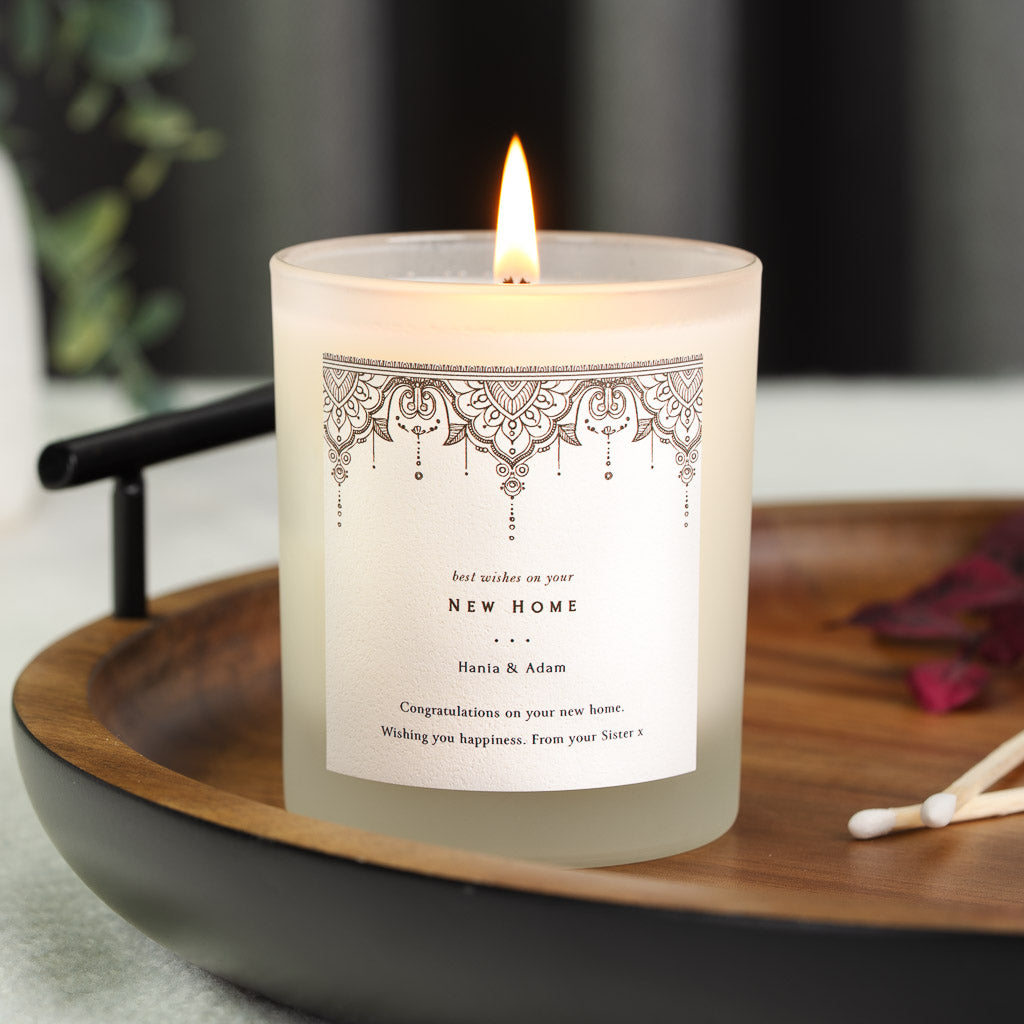 Patterned border above best wishes lettering on a personalised new home candle label